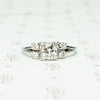 double diamond sides flank a square set round diamond in 14k white gold engagement ring