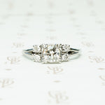 double diamond sides flank a square set round diamond in 14k white gold engagement ring