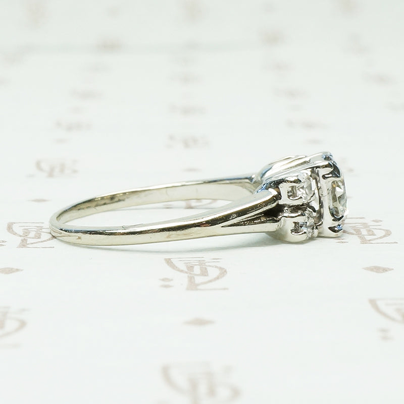 double diamond sides flank a square set round diamond in 14k white gold engagement ring