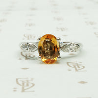 1 carat oval imperial topaz flanked by .20ct marquise diamonds in platinum intage engagement ring