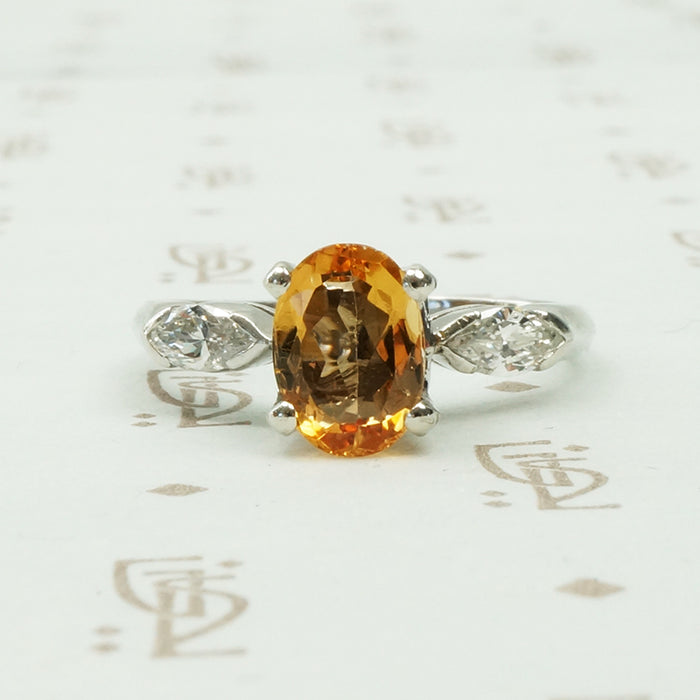1 carat oval imperial topaz flanked by .20ct marquise diamonds in platinum intage engagement ring