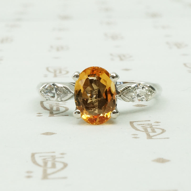 1 carat oval imperial topaz flanked by .20ct marquise diamonds in platinum intage engagement ring