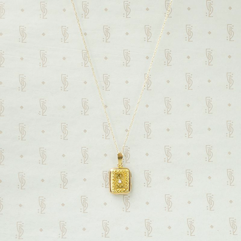 Delicate Gold Filigree Locket with Diamond Accent