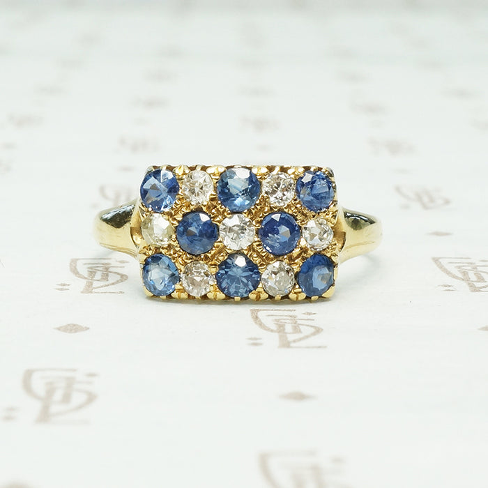 cornflower blue sapphires alternate with little round diamonds in the pavé rectangle 18k yellow gold ring from chester england