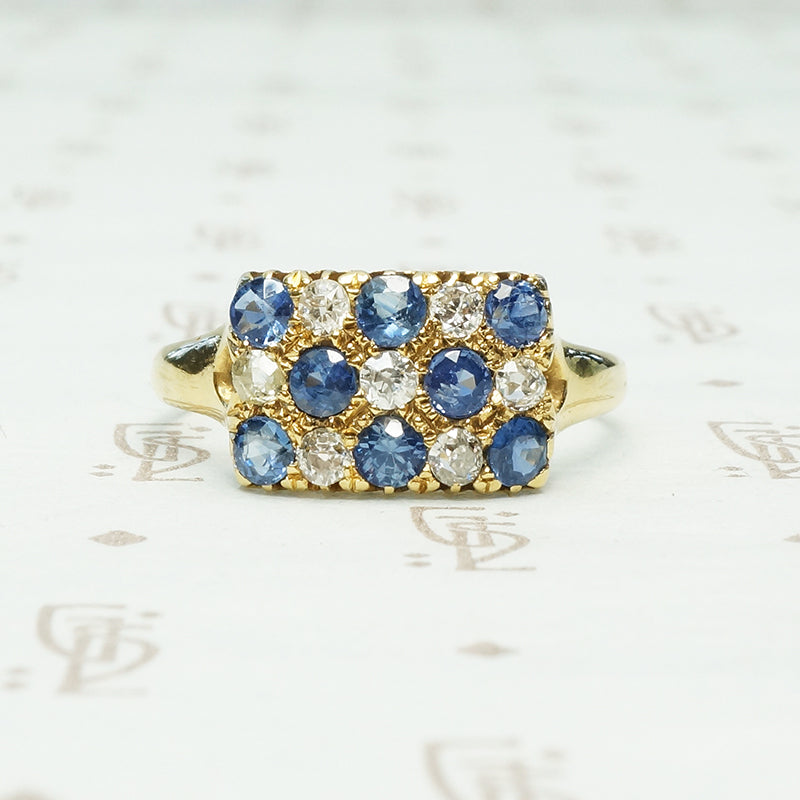 cornflower blue sapphires alternate with little round diamonds in the pavé rectangle 18k yellow gold ring from chester england