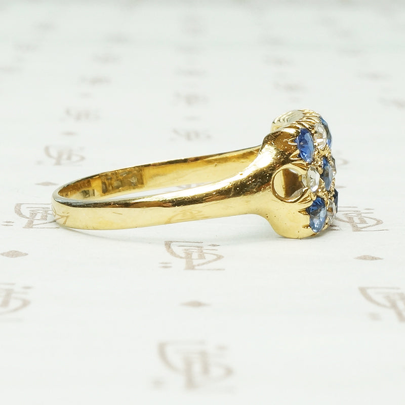 cornflower blue sapphires alternate with little round diamonds in the pavé rectangle 18k yellow gold ring from chester england