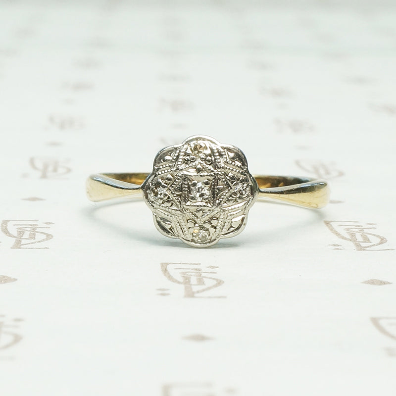 platinum on 9k yellow gold highly detailed flower shaped top with tiny diamonds