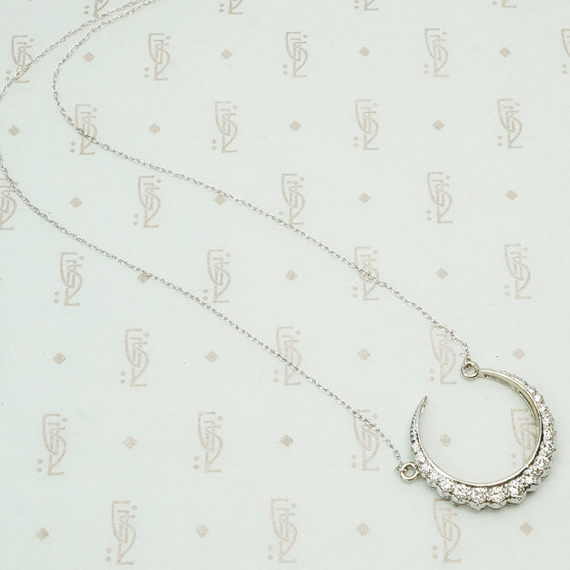 18k white gold crescent moon necklace set with round diamonds