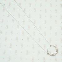 18k white gold crescent moon necklace set with round diamonds