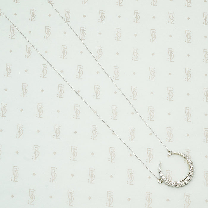 18k white gold crescent moon necklace set with round diamonds