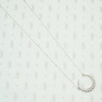 18k white gold crescent moon necklace set with round diamonds
