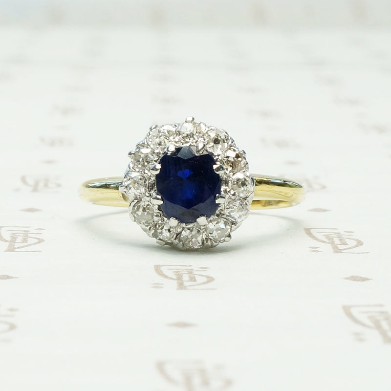 chunky omc diamond halo around oval blue sapphire in 18k yellow gold and platinum ring circa 1930