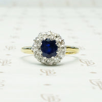 chunky omc diamond halo around oval blue sapphire in 18k yellow gold and platinum ring circa 1930