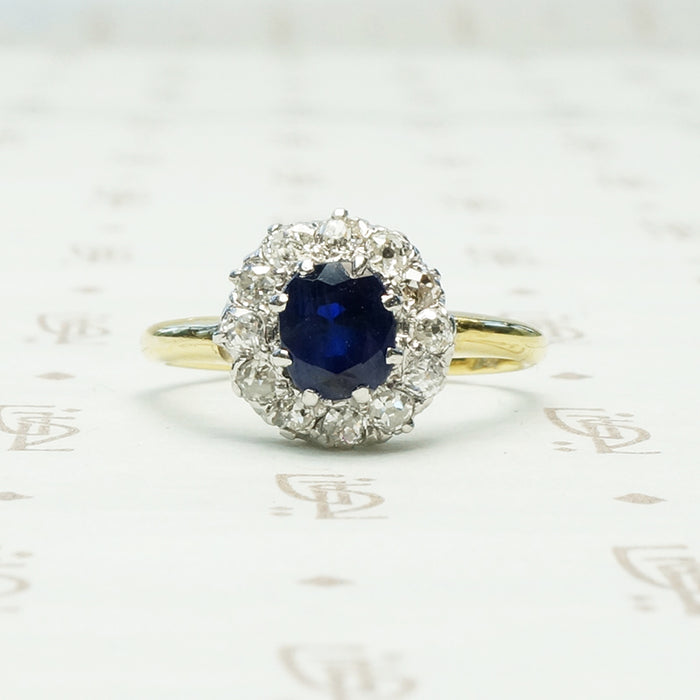 chunky omc diamond halo around oval blue sapphire in 18k yellow gold and platinum ring circa 1930