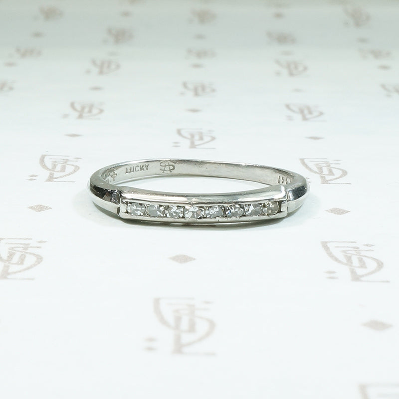 Platinum and channel set diamond band from the 1930's signed Lucky