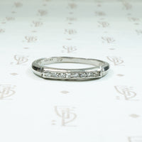 Platinum and channel set diamond band from the 1930's signed Lucky