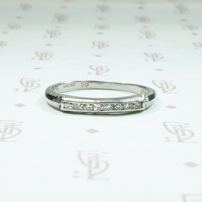 Platinum and channel set diamond band from the 1930's signed Lucky