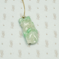 Auspicious Carved Jade Pendant with Pomegranate, Plum and Frog, detail view.