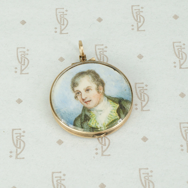 miniature painting and woven hair in a 14k yellow gold double sided crystal locket
