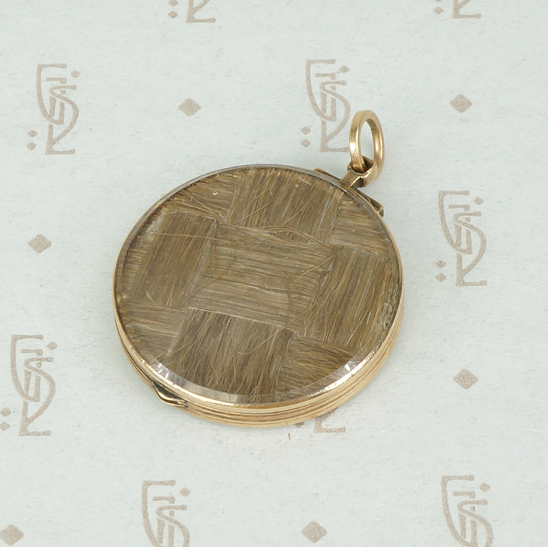 miniature painting and woven hair in a 14k yellow gold double sided crystal locket