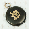 large gunmetal and rose gold locket with the letter M
