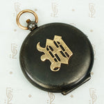 large gunmetal and rose gold locket with the letter M