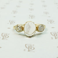 vintage moonstone in its original setting flanked by bezel set old diamonds in 14k recycled yellow gold ring