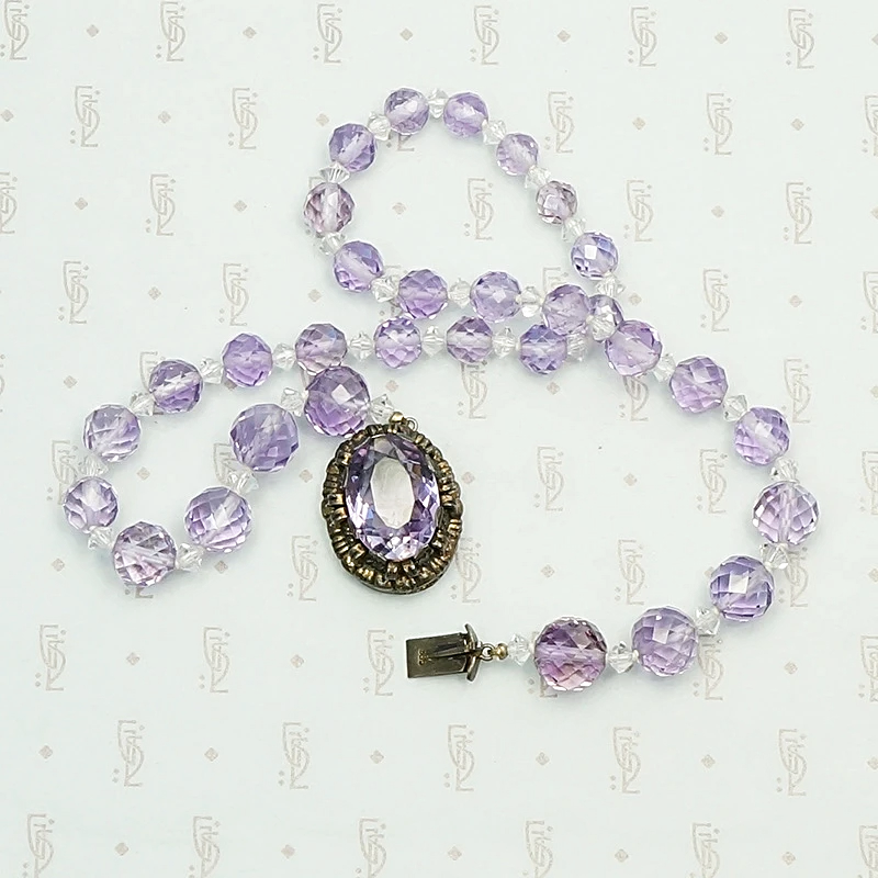 1920s Amethyst Bead Necklace with Decorative Clasp. Coiled view.