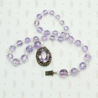 1920s Amethyst Bead Necklace with Decorative Clasp. Coiled view.