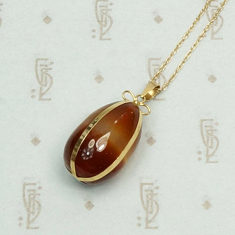 Agate Pendant Gift Wrapped in Gold Ribbon, detail view.