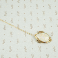 Large oval opal set in floral 14k yellow gold frame