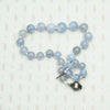 Blue Lace Agate Beads with Decorative Silver Clasp. Coiled view.