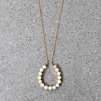 Fortuitous Pearl-Set Gold Horseshoe Pendant