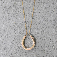Fortuitous Pearl-Set Gold Horseshoe Pendant