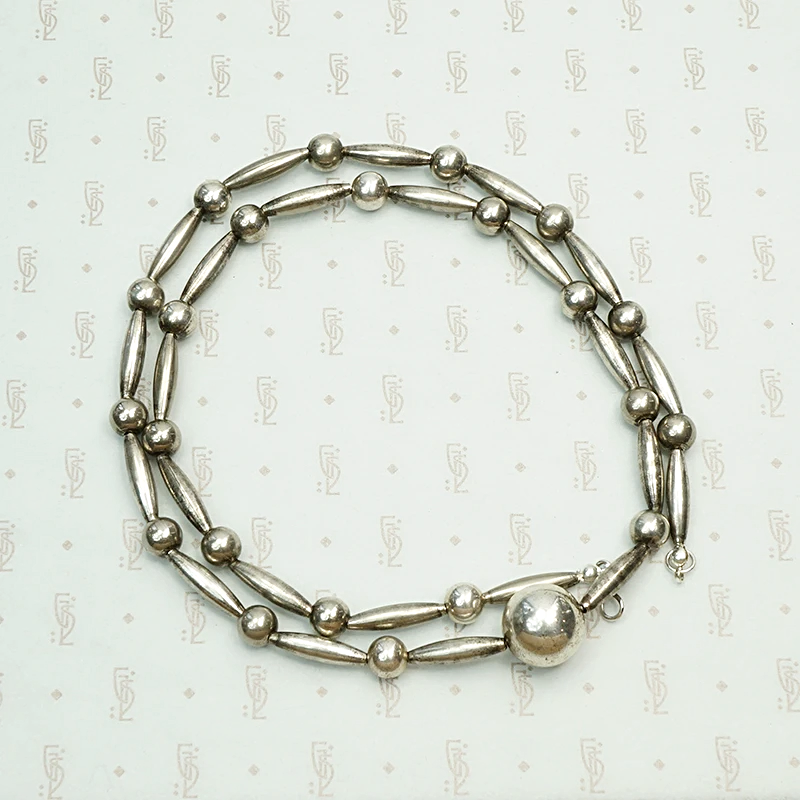 Navajo Handmade Silver Bead Necklace, coiled view.
