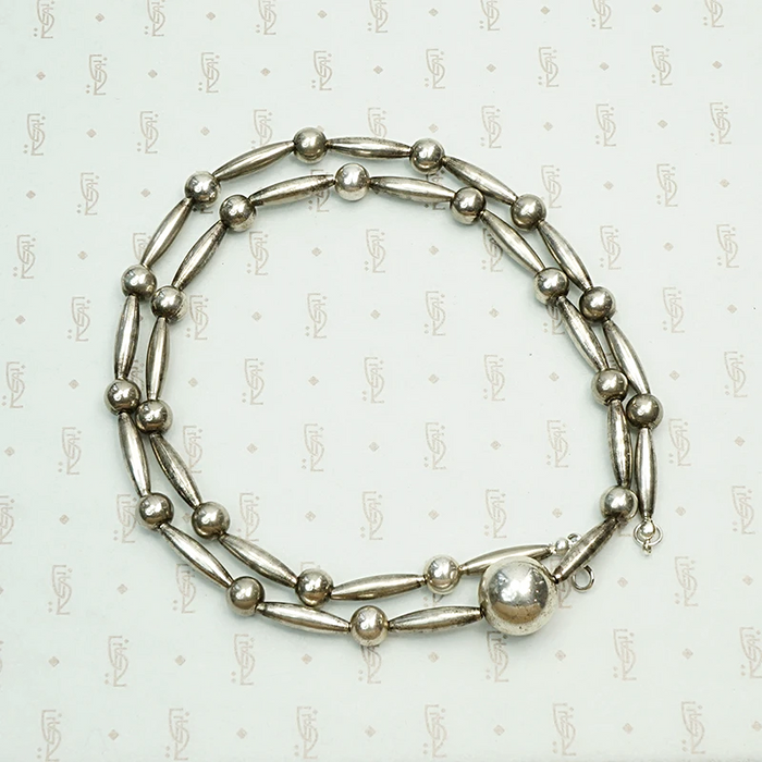 Navajo Handmade Silver Bead Necklace, coiled view.