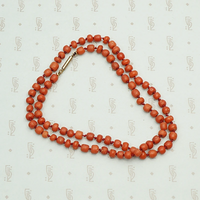 Deep Red Antique Coral Beads on Silk, coiled.