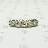 7 stone cushion cut diamond band platinum on 18k yellow gold circa 1900