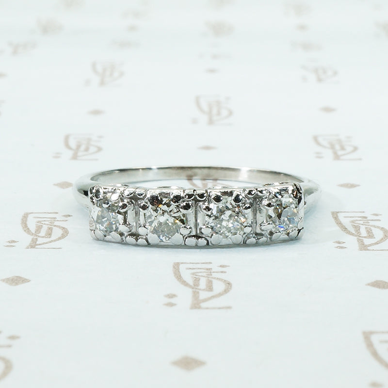 four chunky old mine cut diamonds in a platinum band setting
