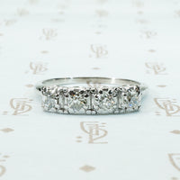 four chunky old mine cut diamonds in a platinum band setting
