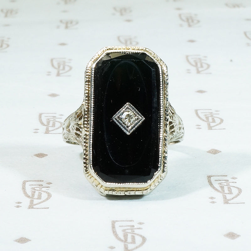 14k white gold filigree black onyx ring with a tiny diamond set in the onyx 