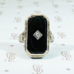 14k white gold filigree black onyx ring with a tiny diamond set in the onyx 