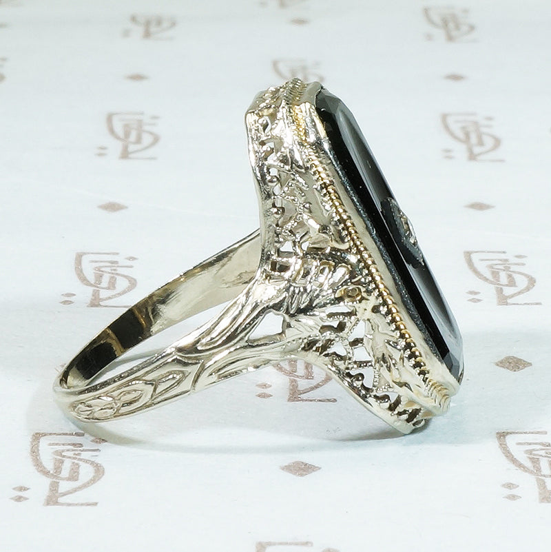 14k white gold filigree black onyx ring with a tiny diamond set in the onyx 