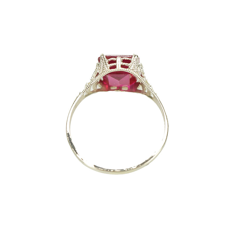 detail view of white gold filigree red ruby ring