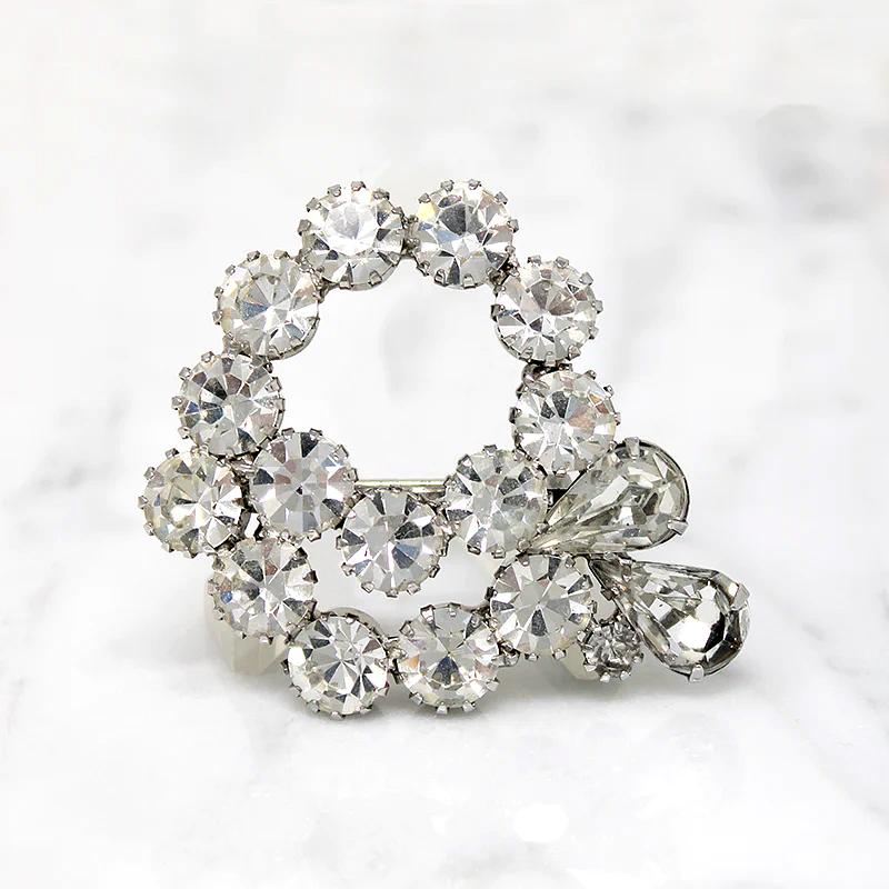 Vivacious White Rhinestone Swirl Brooch