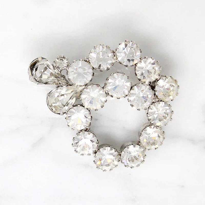 Vivacious White Rhinestone Swirl Brooch