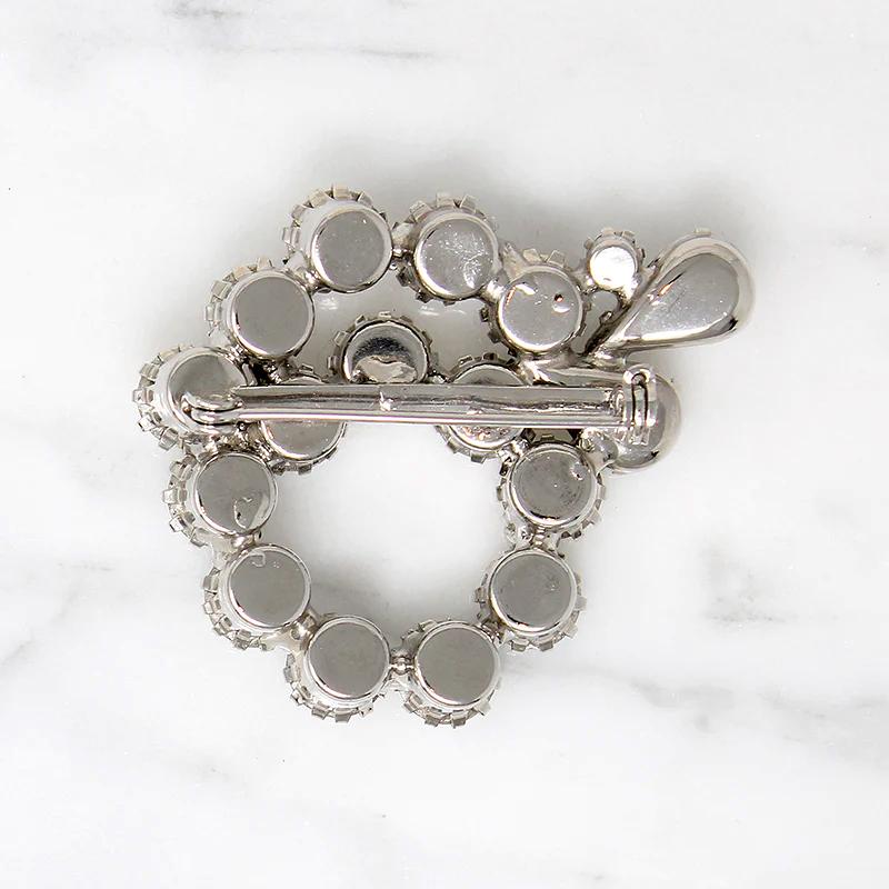 Vivacious White Rhinestone Swirl Brooch
