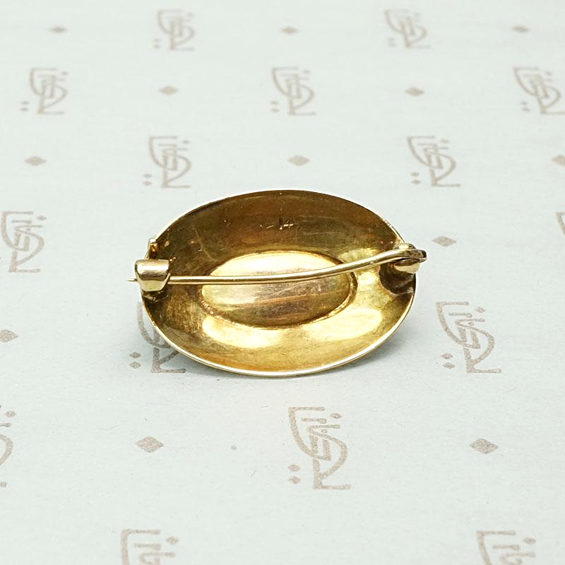 Garnet Cabochon Brooch in Engraved Gold