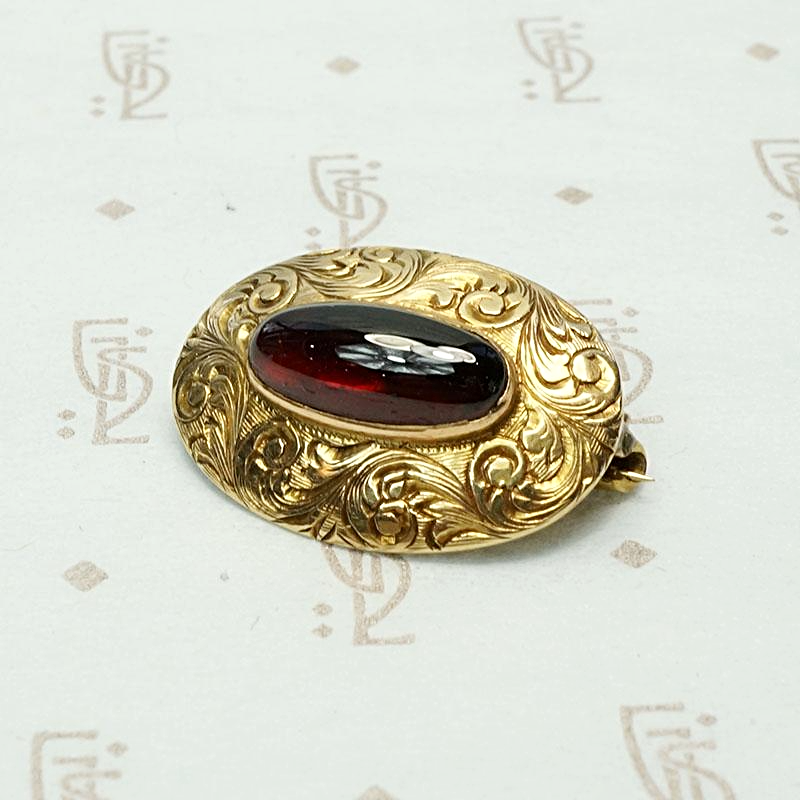 Garnet Cabochon Brooch in Engraved Gold