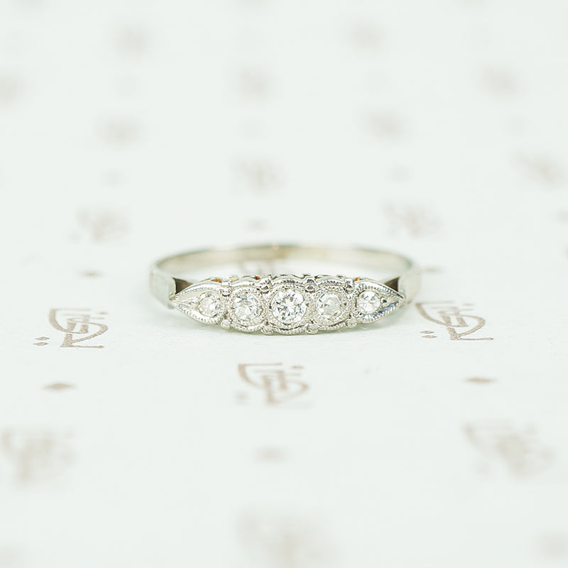 Platinum and white gold diamond band with a paisley like design